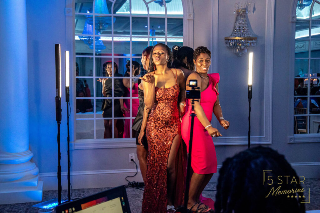 Guests at a wedding or party enjoying getting photos taken on the 360 booth