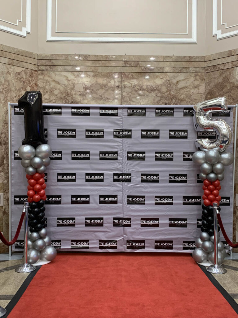 Red carpet photo backdrop and balloon columns