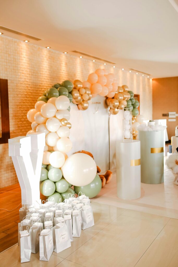 Luxurious event setup featuring a pastel balloon arch and modern decor