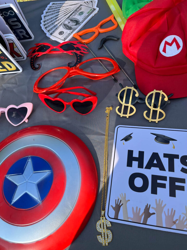 Table with colorful photo booth props including glasses