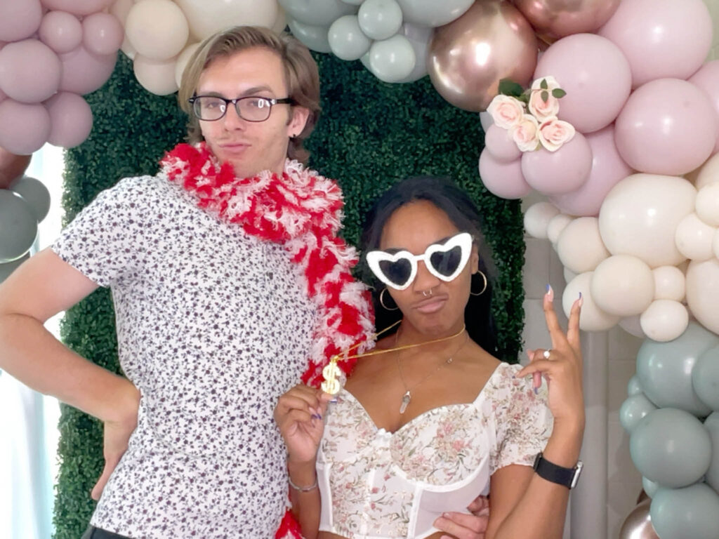 Two guests with props on a photo booth