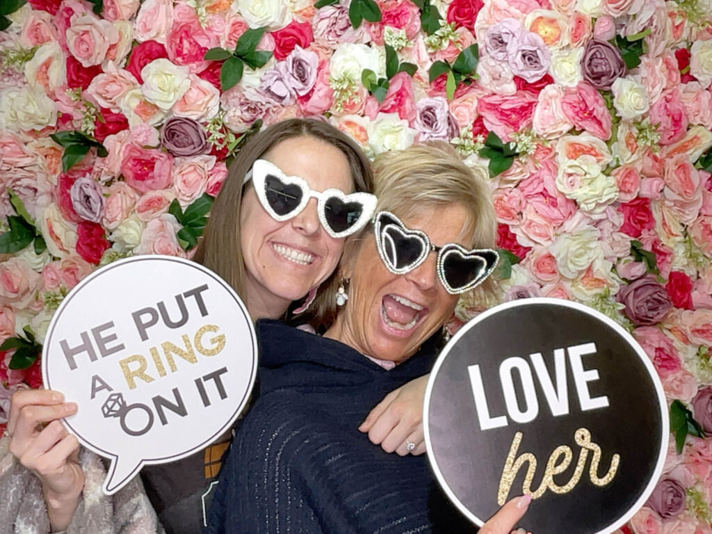 guests holding props on a photo booth