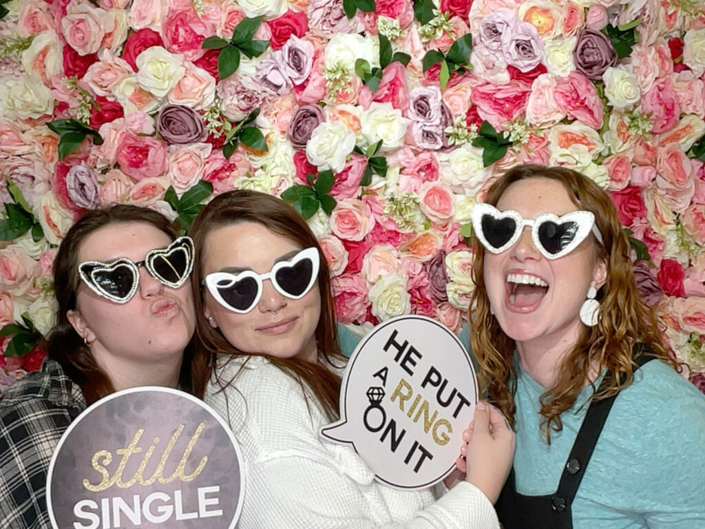 guests holding props on a photo booth